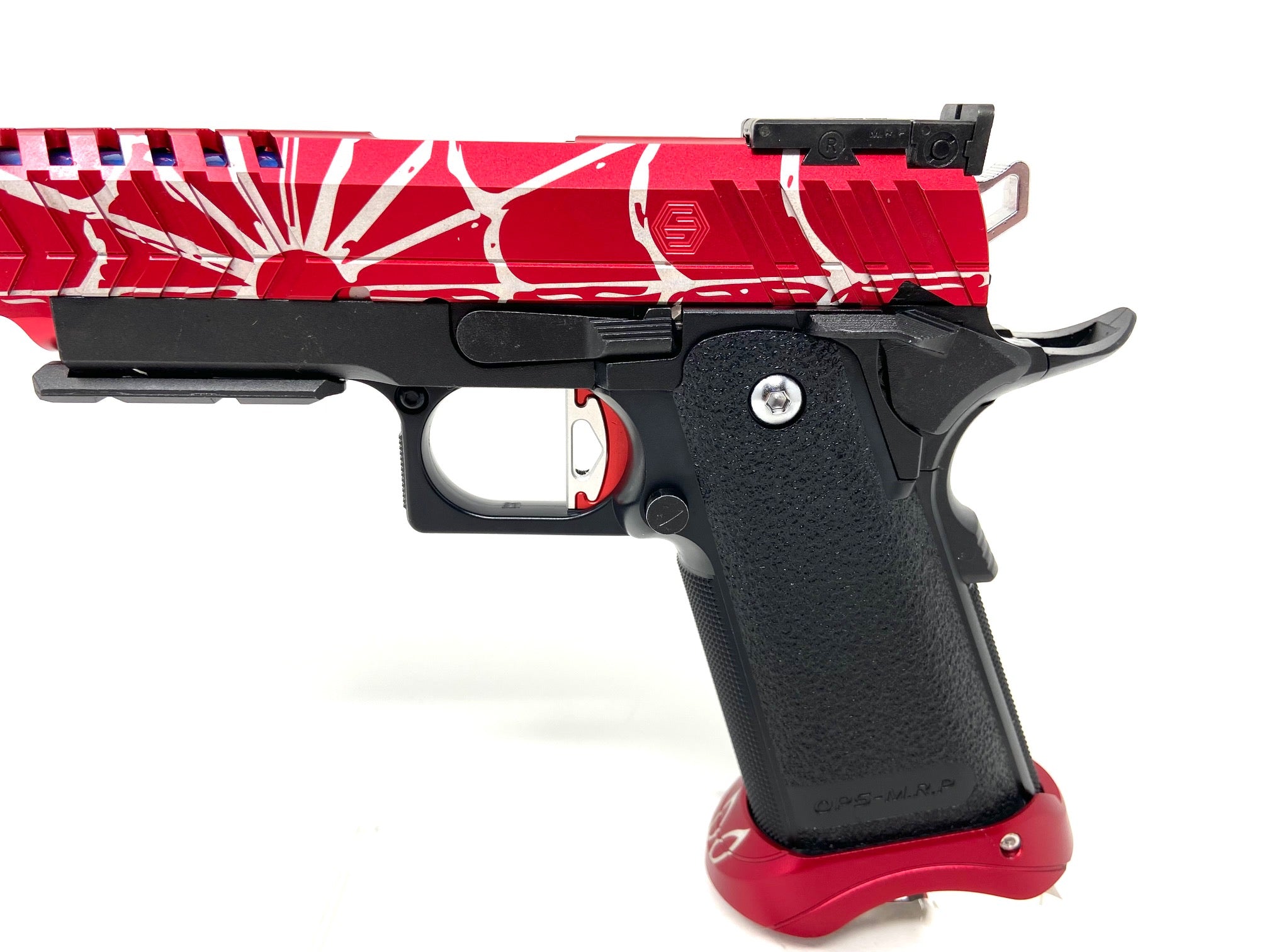Spider Man 2.0 Includes:  Tokyo Marui 5.1 base  Spider Man Laser Engraved Airsoft Masterpiece Edge Max Slide  Spider Man Laser Engraved LA Capa Magwell Red  CowCow NP1 Nozzle Spring  AIP 140% Nozzle Spring  LA Capa Threaded outer barrel  CowCow Red/Silver two piece trigger  CowCow buffer kit
